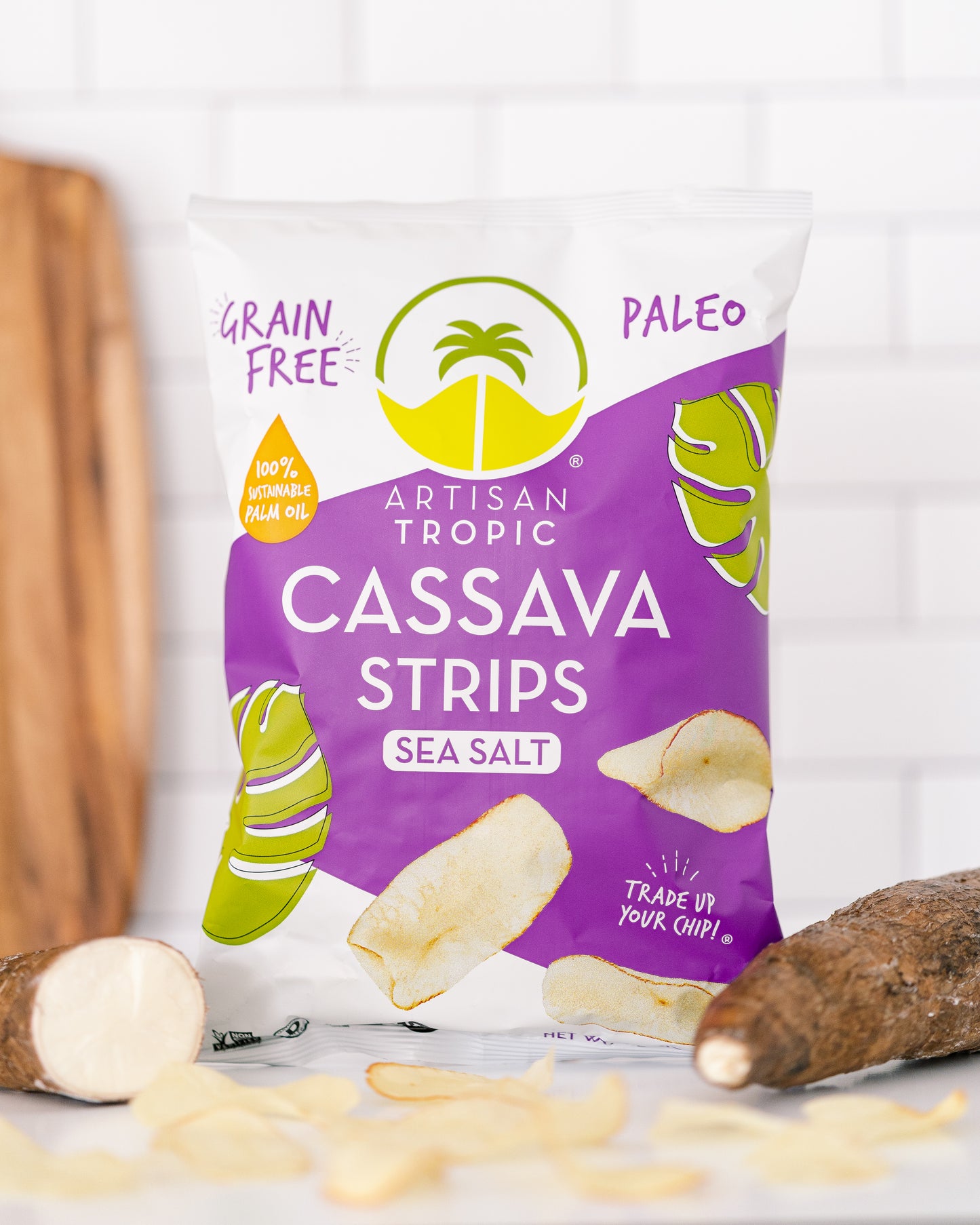 Bag of Artisan Tropic Cassava Strips with cassava root on a white background