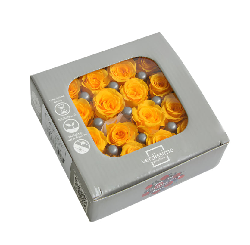 Sixteen warm yellow mini rose heads in a box